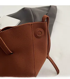 Detail shot of caramel PU leather handbag showing high-quality stitching and matte texture
