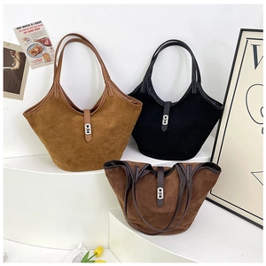 Three minimalist suede tote bags in camel, black, and brown on white display steps