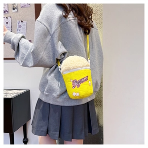 Macro detail of plush popcorn-shaped crossbody bag featuring textured popcorn puff material