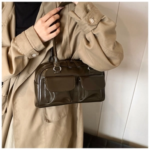Close-up of gloss dark brown PU leather shoulder bag with dual utility flap pockets