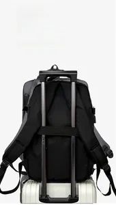 Detail of the black travel backpack with an integrated sleeve for luggage trolley handles