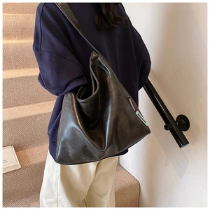 Detail of a black large Hobo tote bag with vintage oil wax leather and brand tags