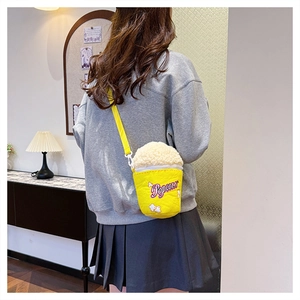 Detail shot of a popcorn-shaped shoulder bag featuring fluffy fleece and yellow canvas material