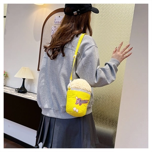 Close-up of creative popcorn-shaped crossbody bag with white fuzzy texture and yellow canvas