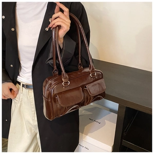 Detailed close-up of glossy dark brown PU leather texture and double front flap pockets