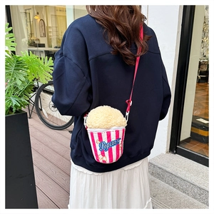 Detail view of pink striped popcorn cross-body bag with soft plush top and red strap