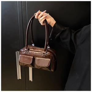 Close-up of deep brown glossy PU leather shoulder bag featuring two front flap pockets