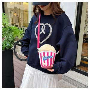 Detailed view of creative popcorn-shaped crossbody bag with red and white striped texture