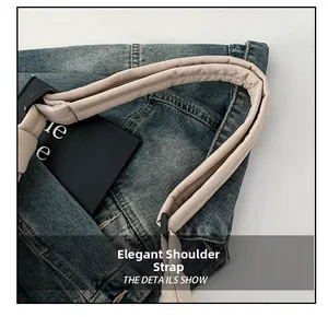 Exquisite padded beige shoulder strap with contrast blue denim bag material details