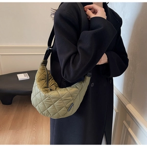 Olive green quilted crescent bag with adjustable wide shoulder strap and zip closure