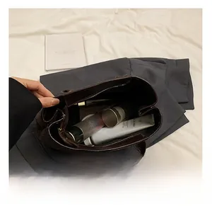 Detailed view showing the large internal storage capacity of the dark brown PU leather bag