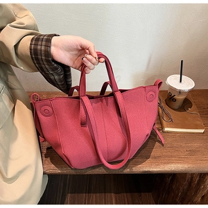Detailed macro view of the fuchsia textured fabric tote bag with functional drawstring sides