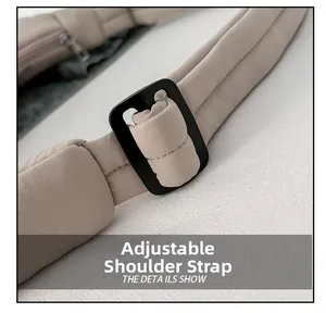 Detail of adjustable nylon shoulder strap with plastic buckle and small zipper pocket
