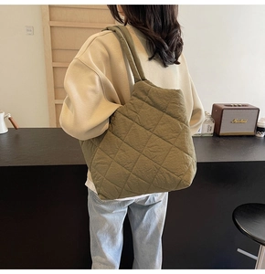 Detail of olive green quilted hobo bag featuring classic diamond pattern nylon fabric