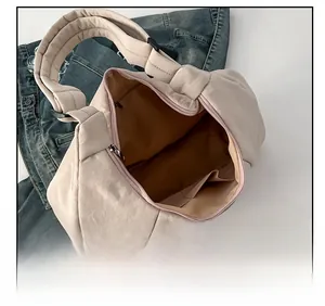 Detail view of the spacious inner compartment and functional pockets of the crossbody bag
