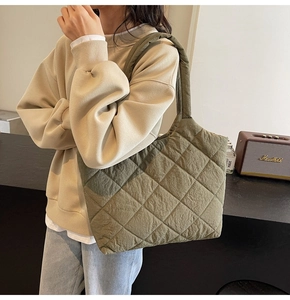 Detail of olive green quilted tote bag showing rhombus stitching and soft texture