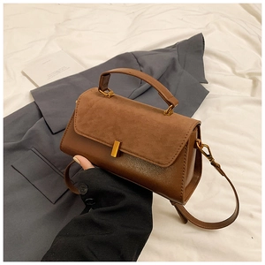 Brown vintage faux leather crossbody bag with suede flap and gold metal hardware handles