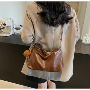 Deep brown PU leather shoulder bag with vintage style and plush bear charm detail