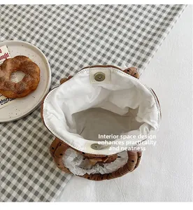 Dettaglio della borsa a secchiello a pois marroni con chiusura magnetica e pizzo