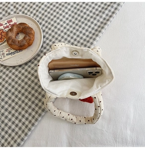 Internal view of the cream polka dot cotton bag showing phone and wallet storage