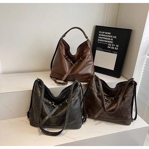 Three oversized hobo shoulder bags in vintage black, dark brown, and caramel PU leather