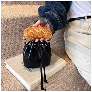 Detail view of black drawstring bucket bag featuring unique brown fleece bread-shaped handle