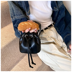 Detail view of black PU leather bucket bag with creative baguette shaped plush handle