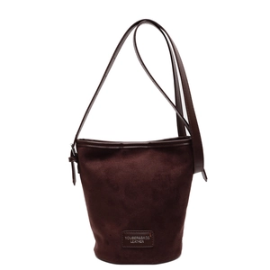 Minimalist dark brown suede bucket bag with leather trim and adjustable shoulder strap