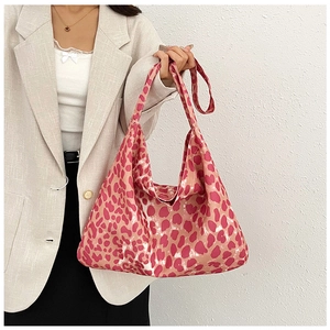 Detailed view of pink leopard print tote bag featuring wide shoulder straps and large capacity