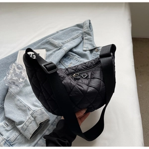 Fashionable black quilted crescent bag with adjustable wide strap and puffer texture
