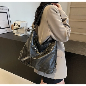Close-up of black PU leather hobo bag with vintage texture and buckle detail on shoulder