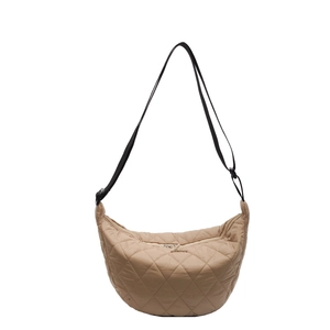 Minimalist beige quilted crescent shoulder bag with adjustable black strap and metal buckle