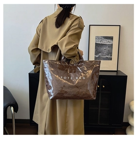 Brown Dupont paper tote bag with waterproof PVC overlay shown on a model in a modern room