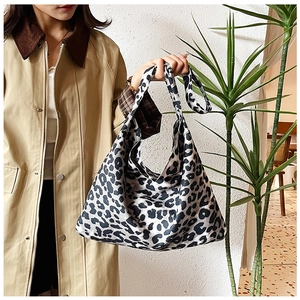 Close-up of leopard print fabric tote bag with comfortable wide shoulder strap design
