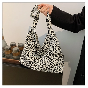 Close-up of stylish leopard print fabric tote bag with soft canvas texture
