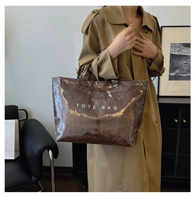 Close-up of brown Tyvek tote bag with crinkle texture and white printed lettering