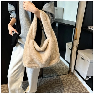 Détail du sac à bandoulière en peluche beige montrant la texture douce et sa capacité