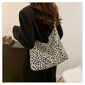 Detail of a black and white leopard print canvas tote bag with large storage capacity