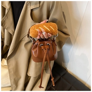 Detail of a brown PU leather bucket bag featuring a unique faux-bread plush handle design
