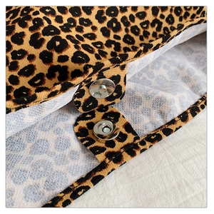 Detail of fabric shoulder bag with leopard print pattern and silver magnetic closure