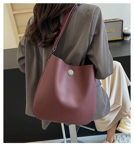 Detail view of burgundy PU leather shoulder bag with vintage silver metal buckle decoration