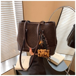 Chic brown woven PU leather tote bag with leopard fur charm and long shoulder strap