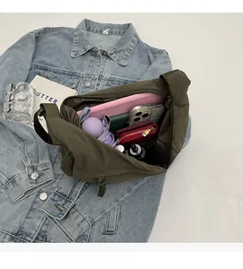 Interior view of large olive green nylon dumpling bag filled with daily essentials