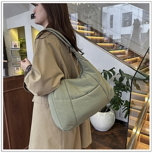 Detail of light green hobo bag showing high-density nylon texture and large capacity