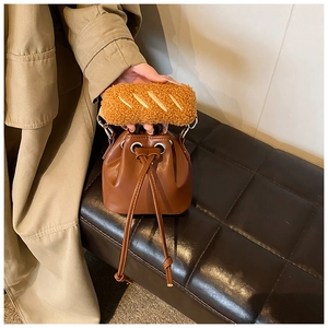 Detail of vintage brown PU leather bucket bag with creative bread-shaped plush handle