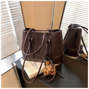 Brown wool tote bag with leather handles and leopard print charm for autumn fashion