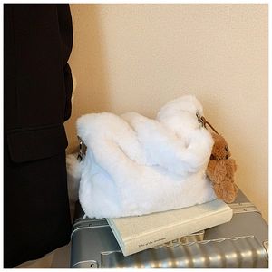 Sac bandoulière chic en fausse fourrure blanche avec charm ours brun sur une valise