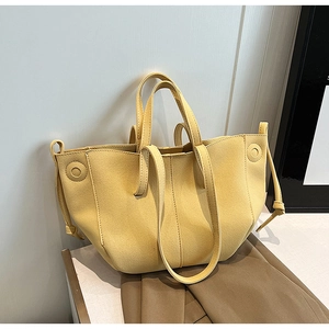 Minimalist light yellow faux suede tote bag with stylish wing design and dual handles