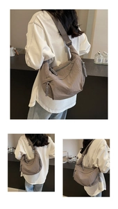 Detail of large nylon dumpling crossbody bag with woven rope zipper and textured fabric