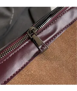 Macro detail of glossy metal zipper and premium canvas stitching on a shoulder bag